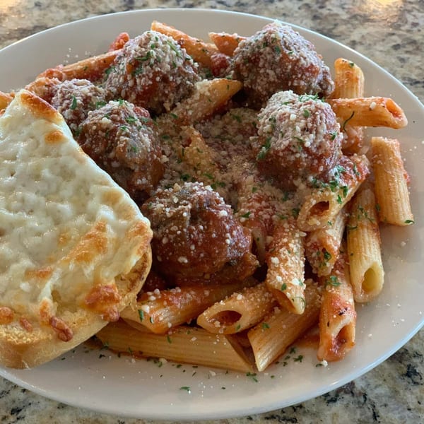 Hardy's catering penne pasta with meatballs, marinara, parmesan, and a side of cheesy garlic bread.